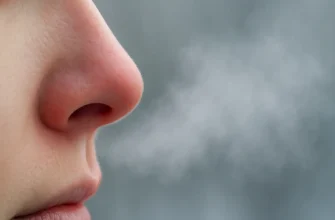Close-up of a cold weather runner’s nose releasing visible breath vapor — illustrating why the nose runs after running in chilly air.