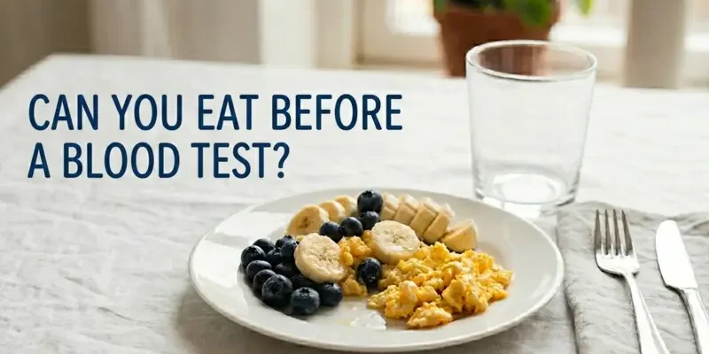 Healthy breakfast plate with blueberries, bananas, and scrambled eggs on a table with the headline "Can You Eat Before a Blood Test?" for iytmed.com by Reyus Mammadli.