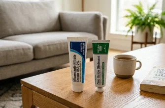 Two tubes of OTC treatment creams for groin irritation, including antifungal and zinc oxide ointment, on a wooden coffee table in a bright, modern living room setting.