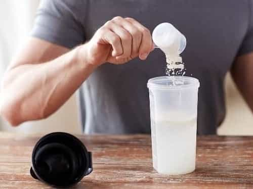 Man is preparing weight gainer shake